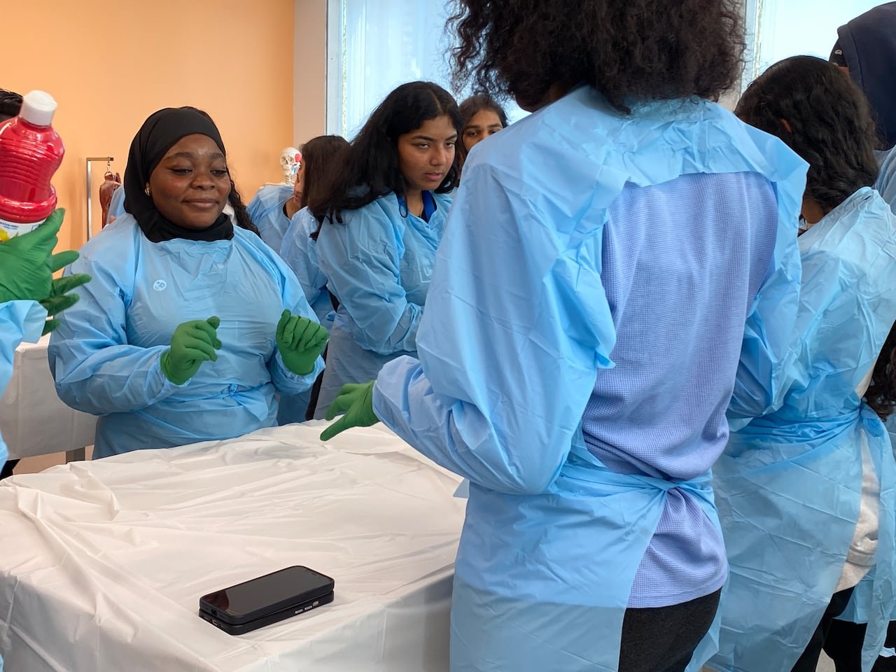 Grade twelve student Aisha Adebisi preparing alongside peers during hands-on activity session